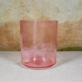 Load image into Gallery viewer, Pink crystal sound bowl on a textured surface with a neutral background