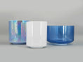 Load image into Gallery viewer, Three crystal sound bowls with iridescent, white, and blue finishes on a gray background
