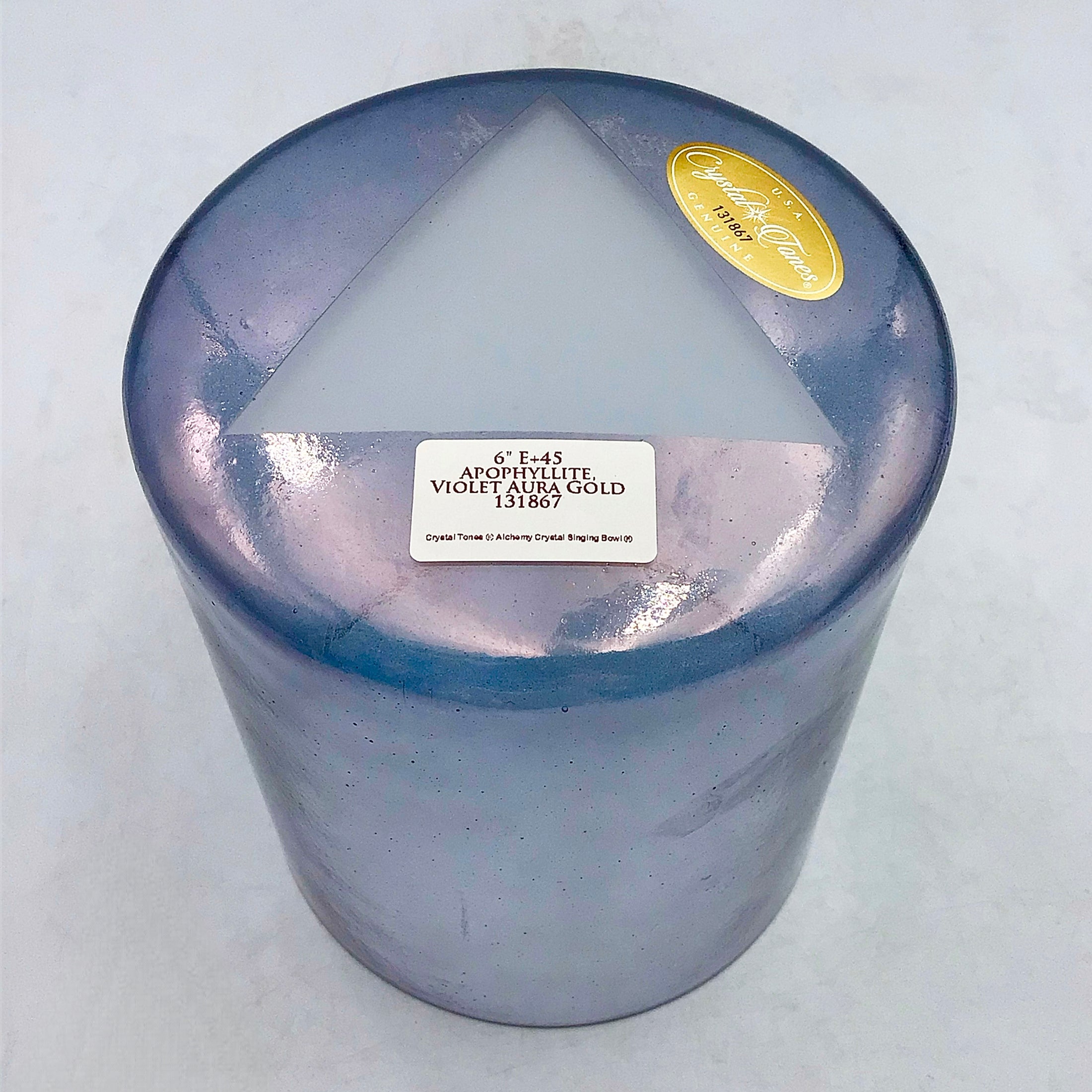 View of the base of a violet crystal sound bowl with an opaque triangle and labels on a white background