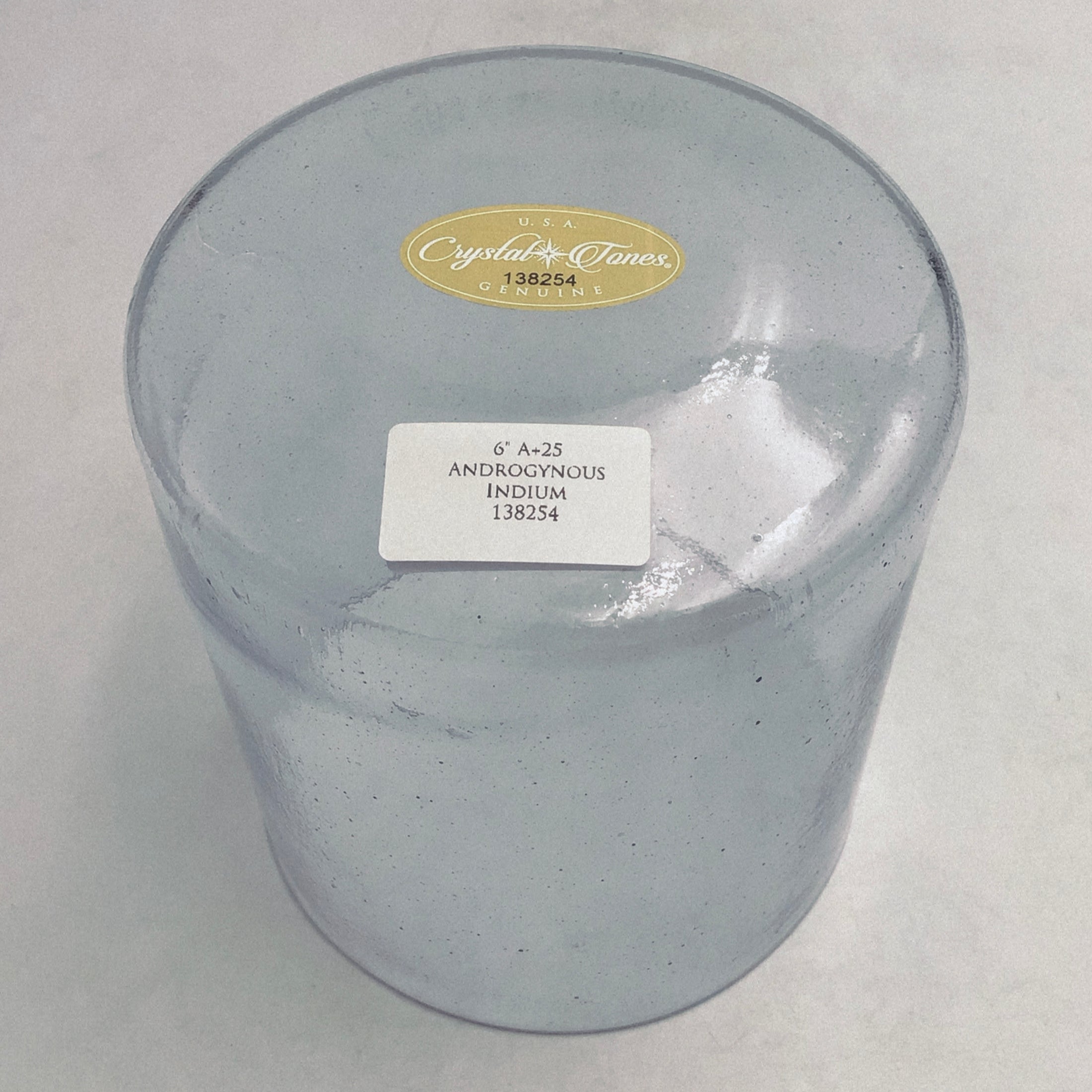 Base view of a clear crystal sound bowl with labels on a white background