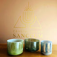 Load image into Gallery viewer, Three Crystal Sound Bowls on a wooden surface with 'Crystal Sound Sanctum' logo in the background.
