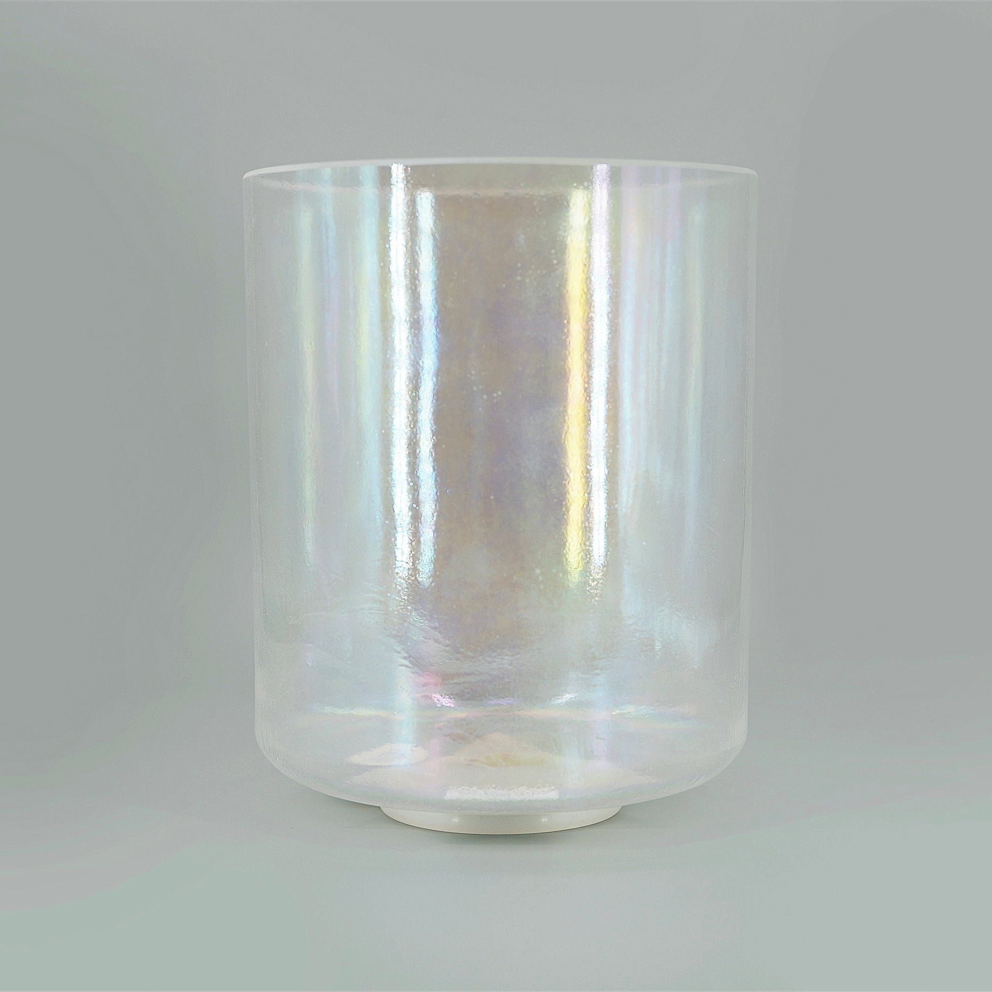 Iridescent crystal sound bowl on a gray background