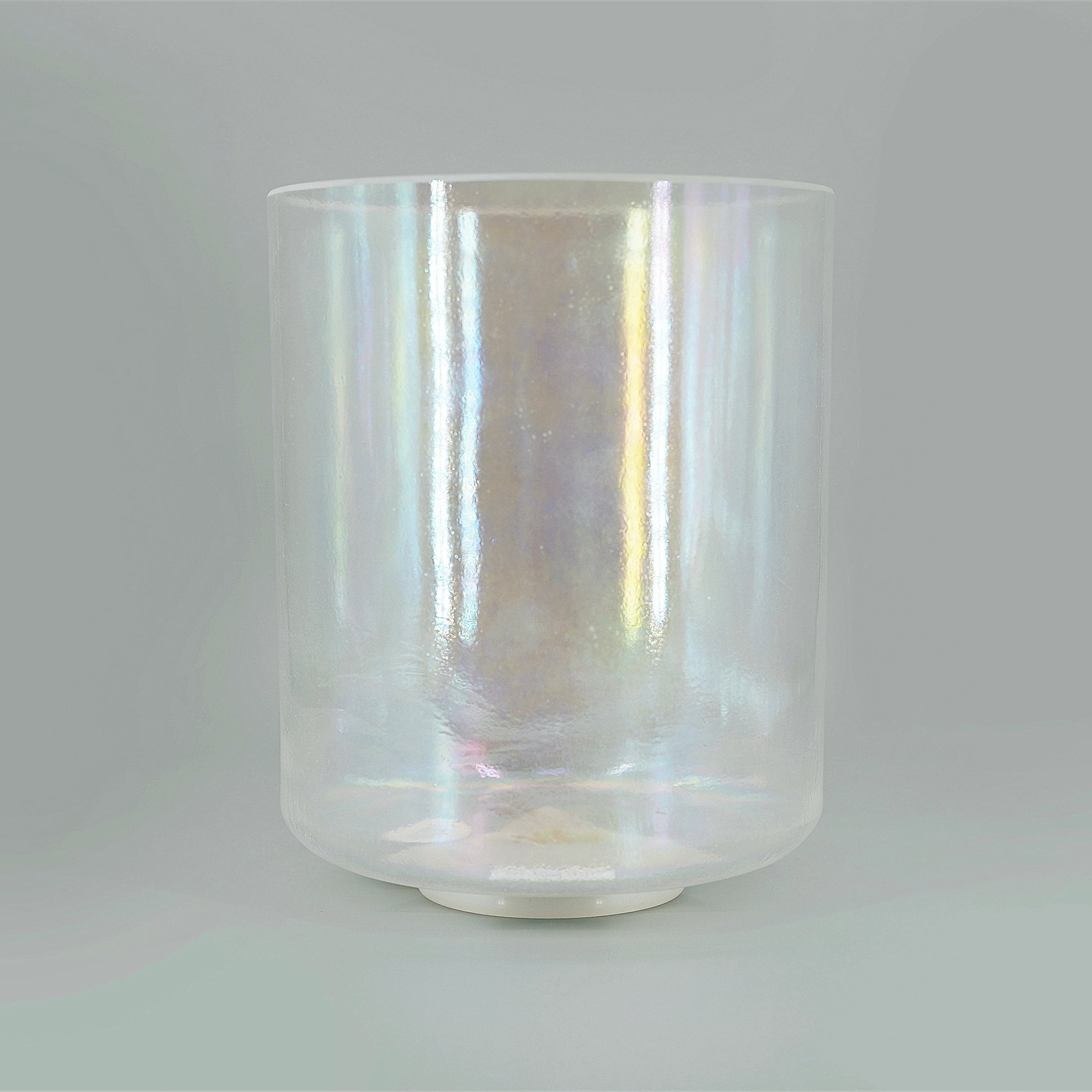 Iridescent crystal sound bowl on a gray background