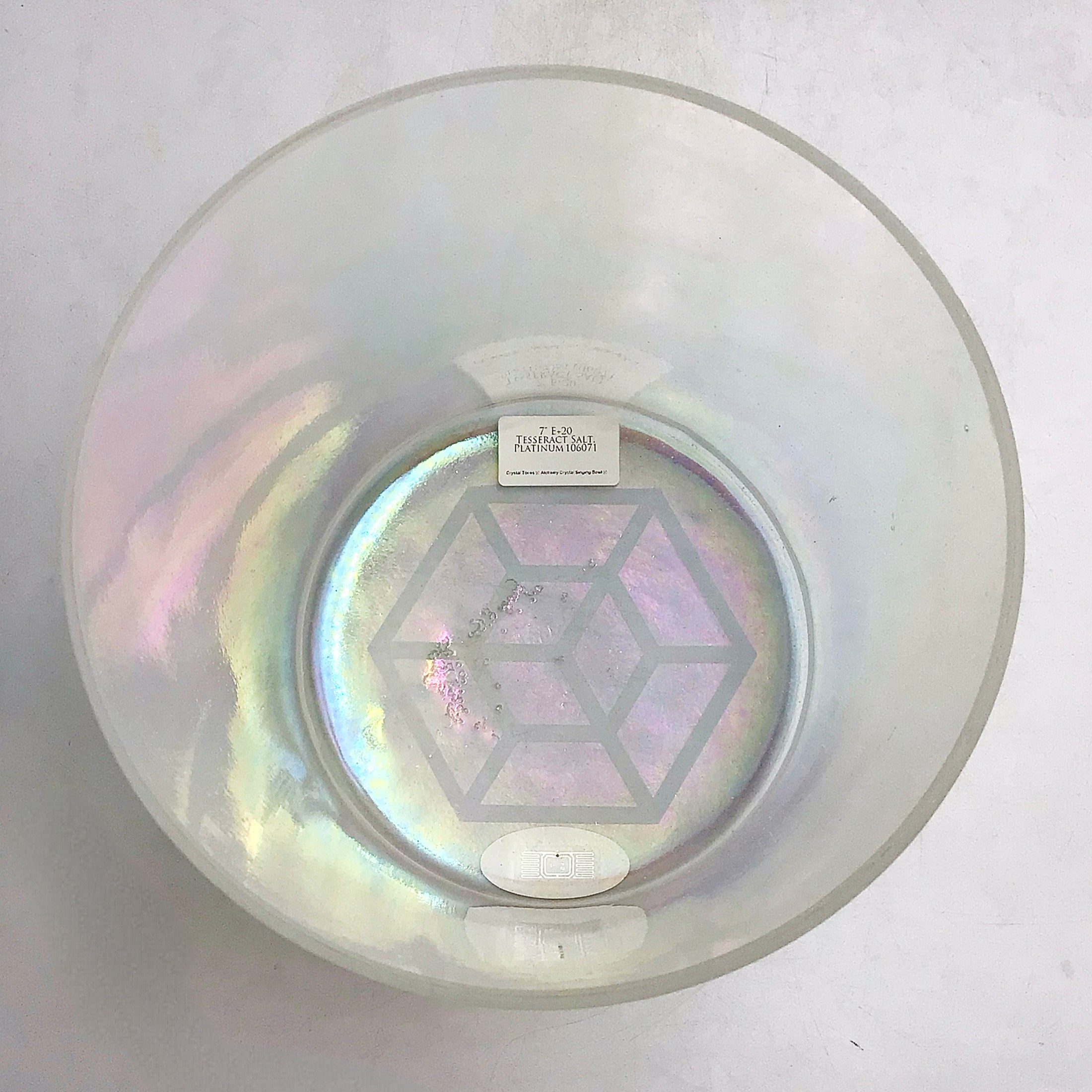 Inside view of an Iridescent Crystal sound bowl on a white gray background with a geometric design