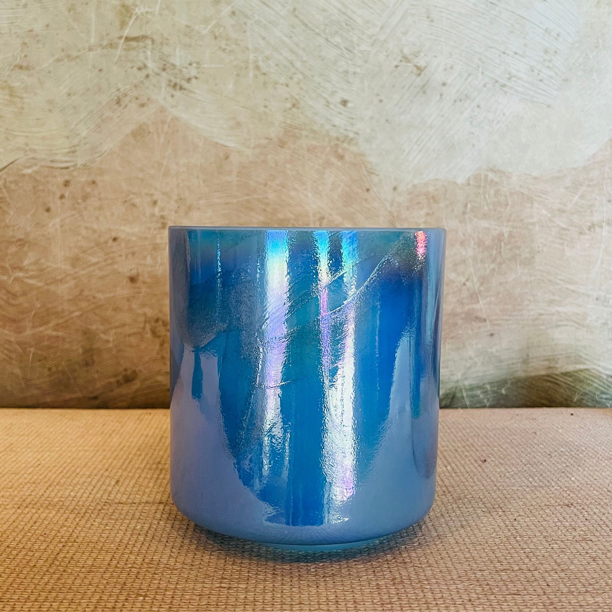 Blue Crystal Sound Bowl on a textured surface with a neutral background