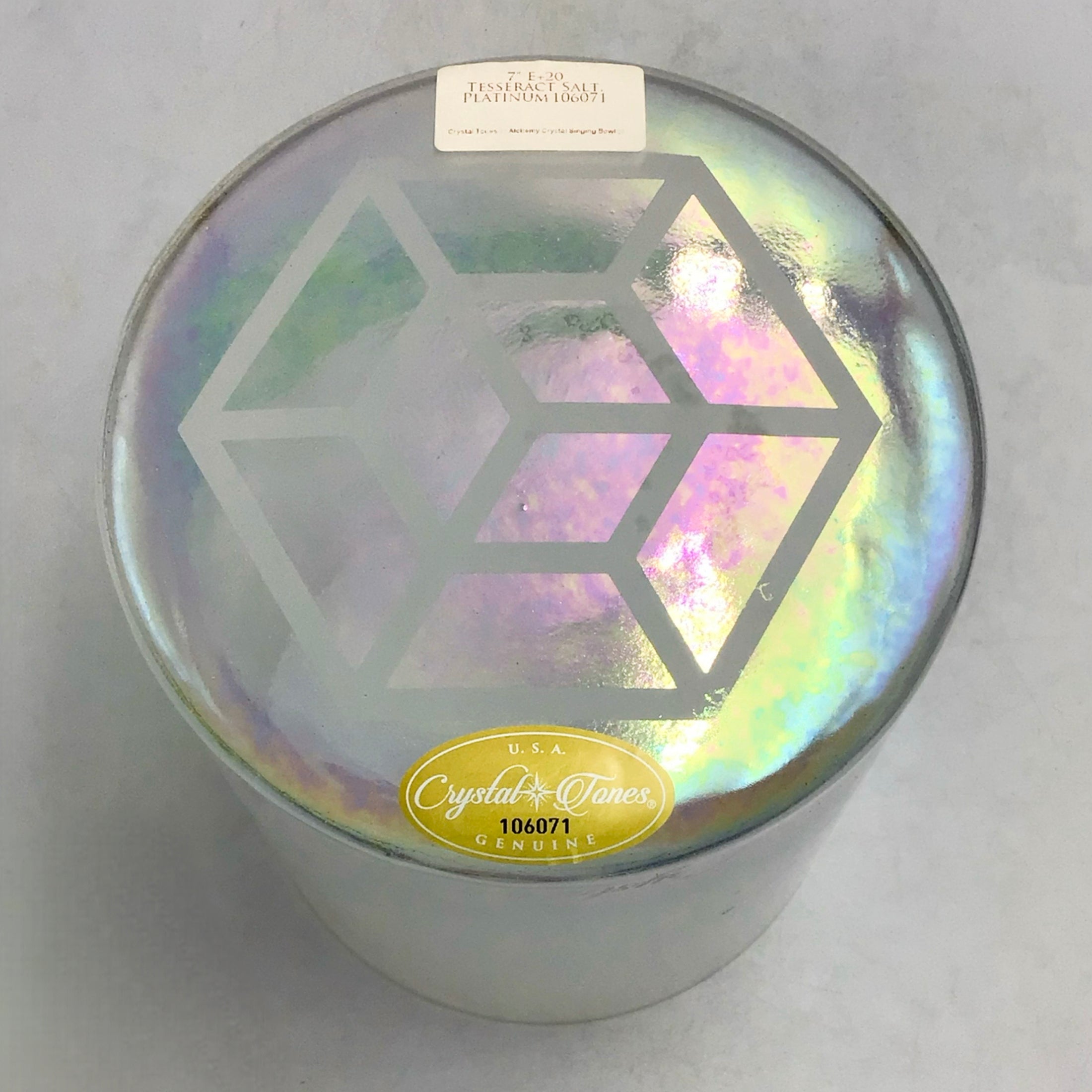 Iridescent crystal sound bowl with geometric design and 'Crystal Tones' label on a gray background