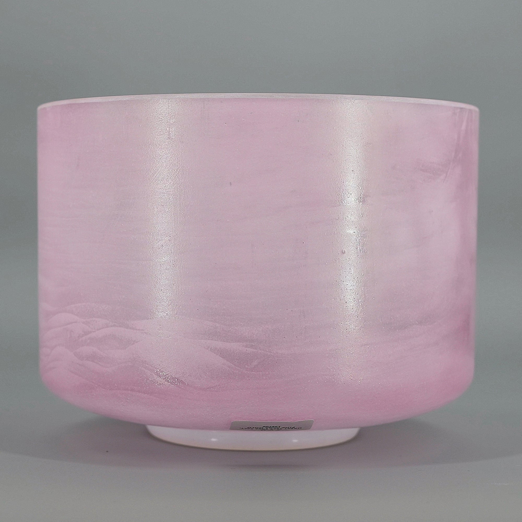Pink crystal sound bowl on a gray background