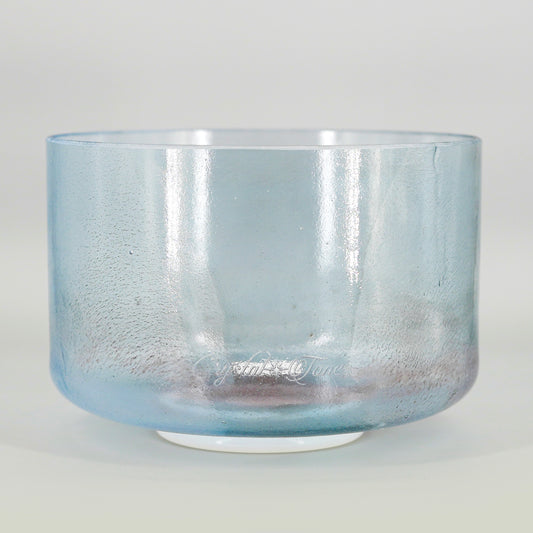 Blue crystal sound bowl on a light gray background