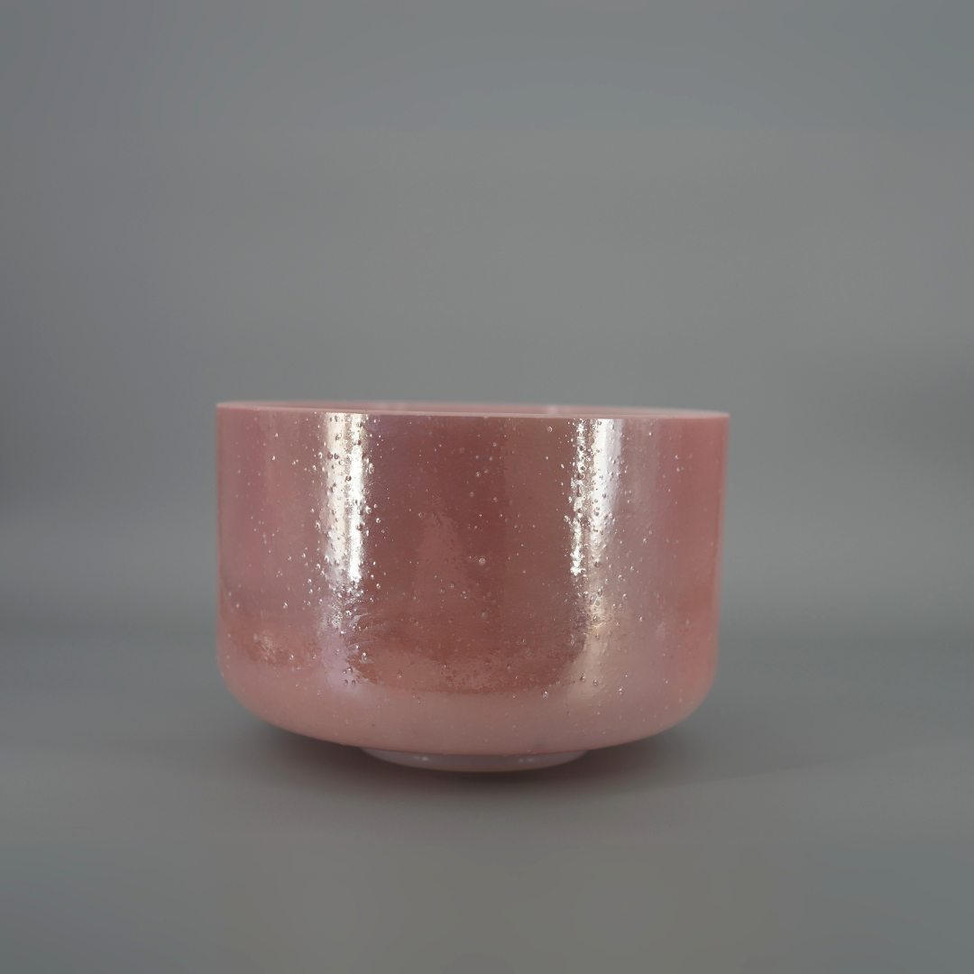 Pink crystal sound bowl on a gray background
