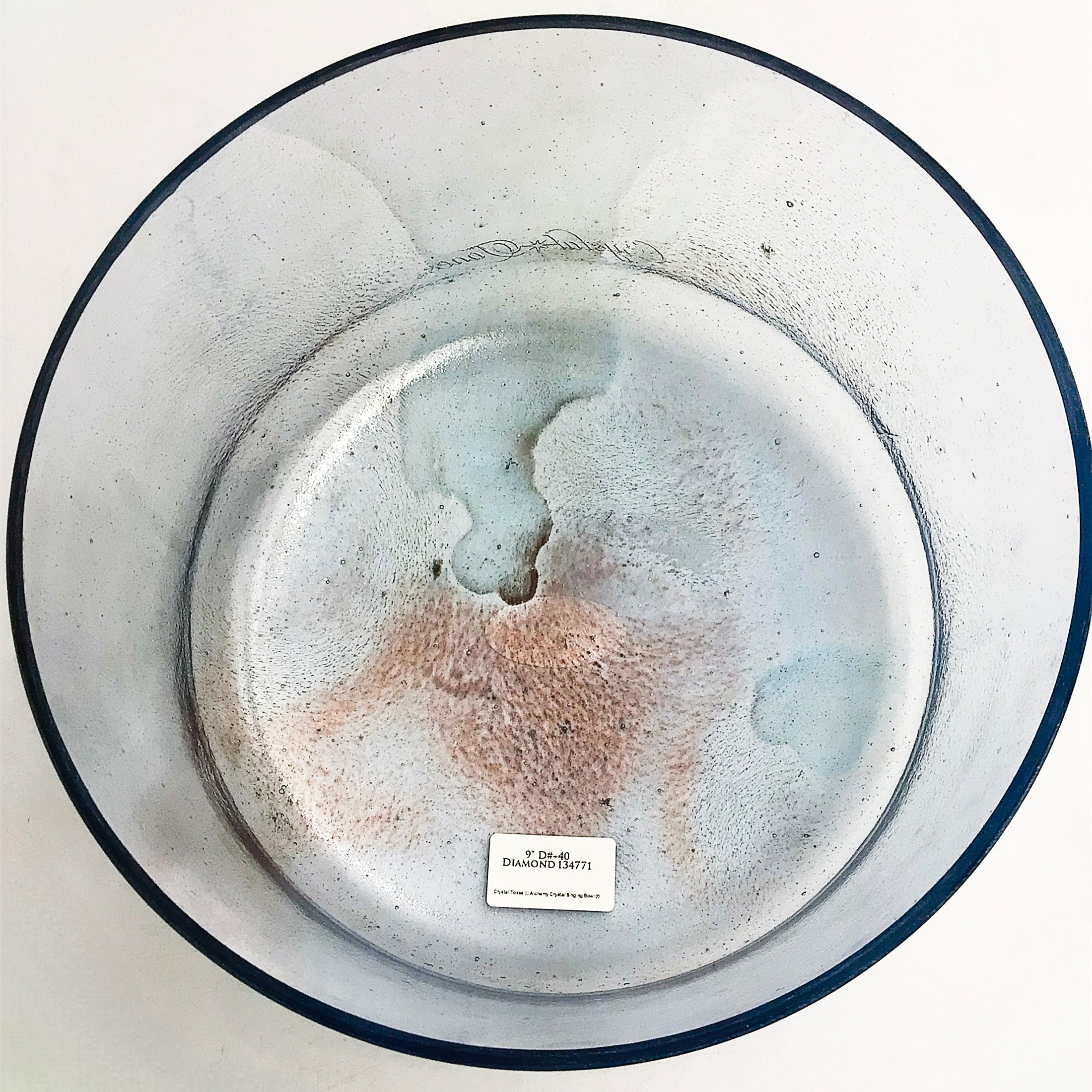 crystal sound bowl with unique markings on a white background