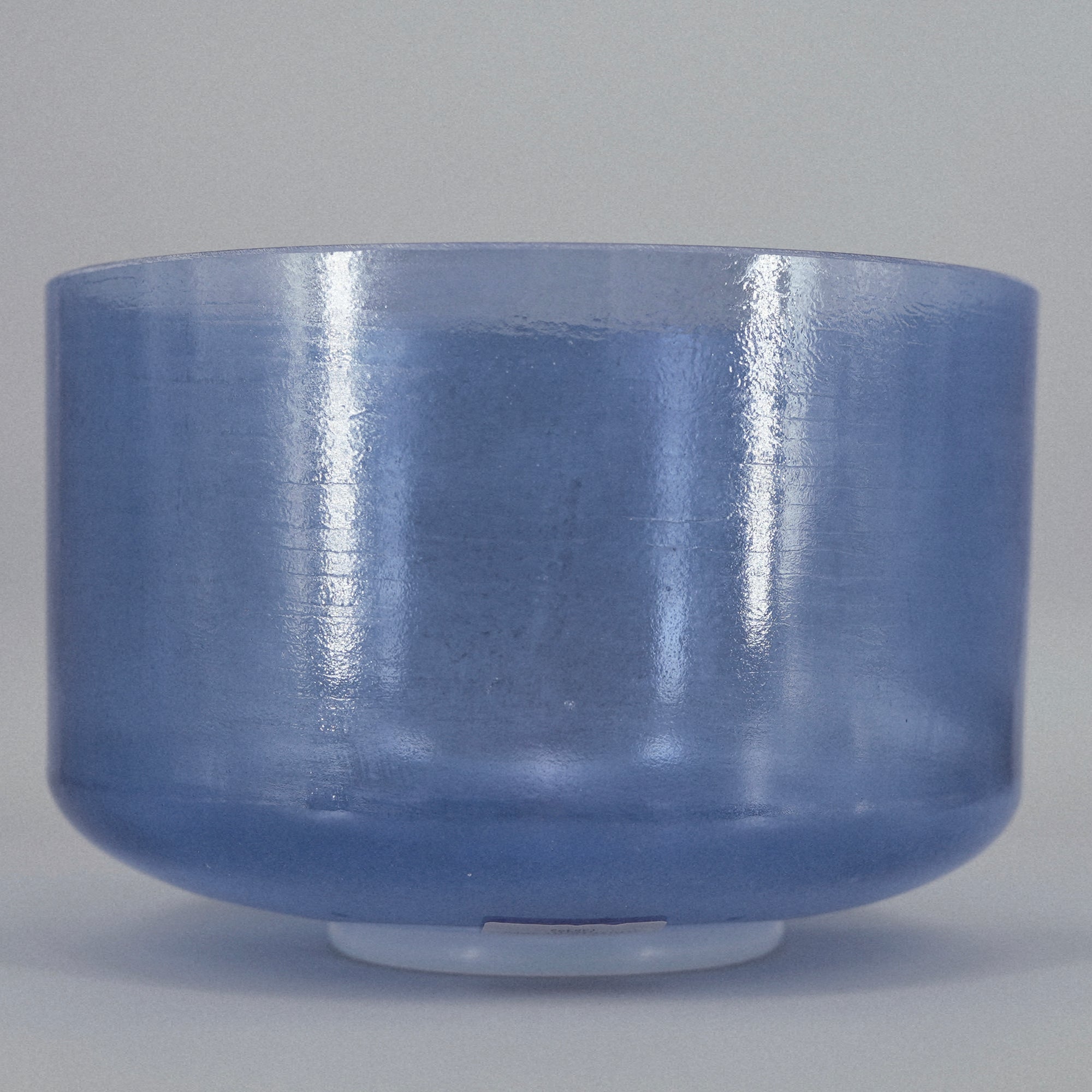 Blue crystal sound bowl on a gray background