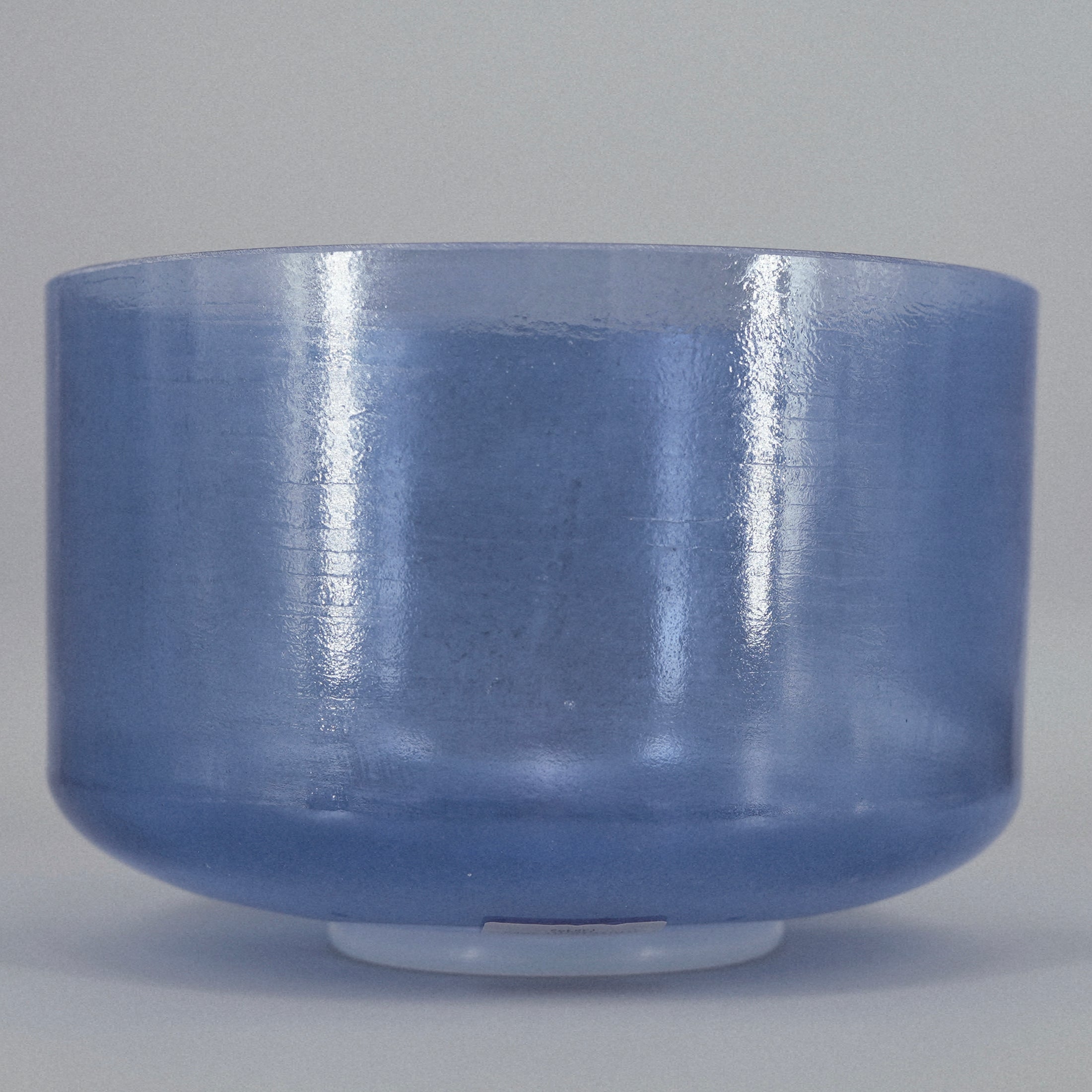 Blue crystal sound bowl on a gray background