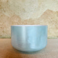 Load image into Gallery viewer, Blue Crystal Sound Bowl on a textured beige surface
