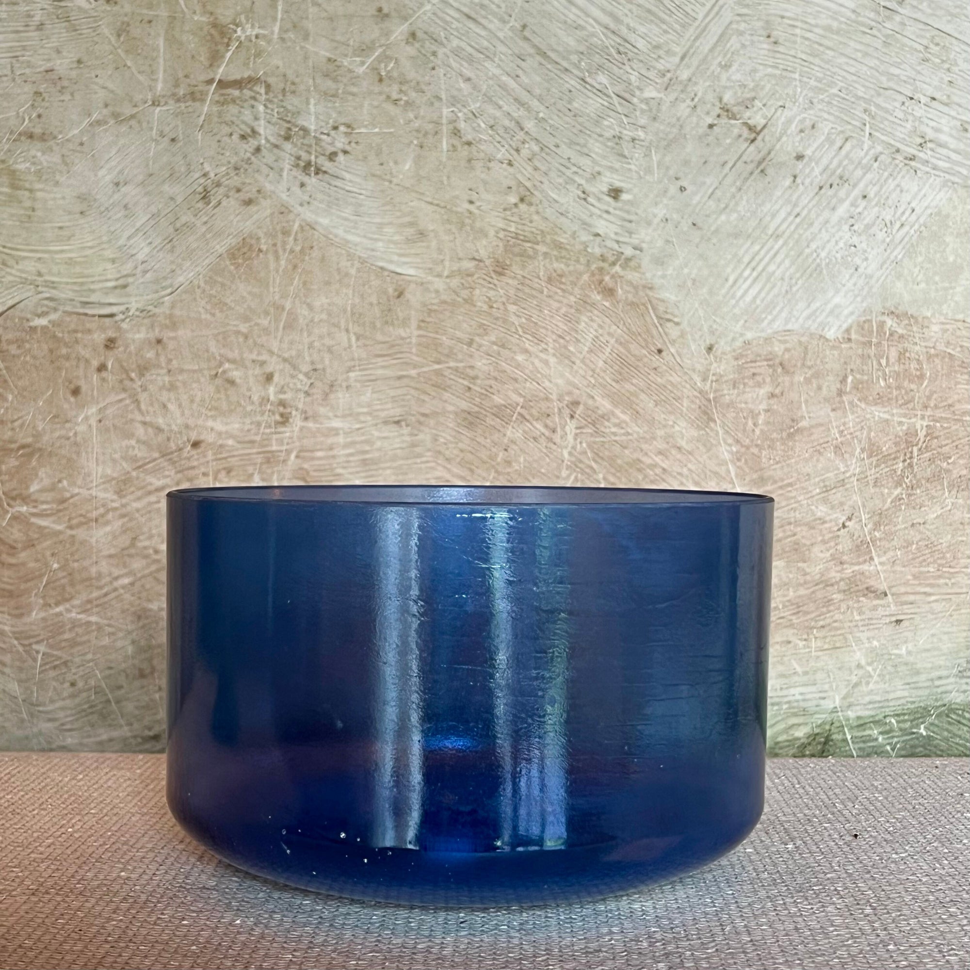 Blue Crystal Sound Bowl on a textured surface