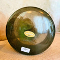 Load image into Gallery viewer, Green Crystal Sound Bowl with a Crystal Tones label on a textured surface
