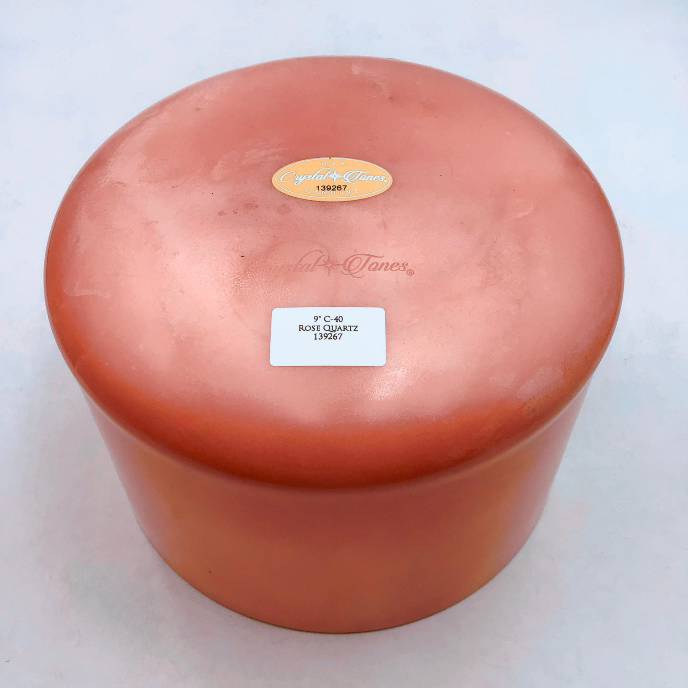 Round crystal sound bowl with a label on a white background