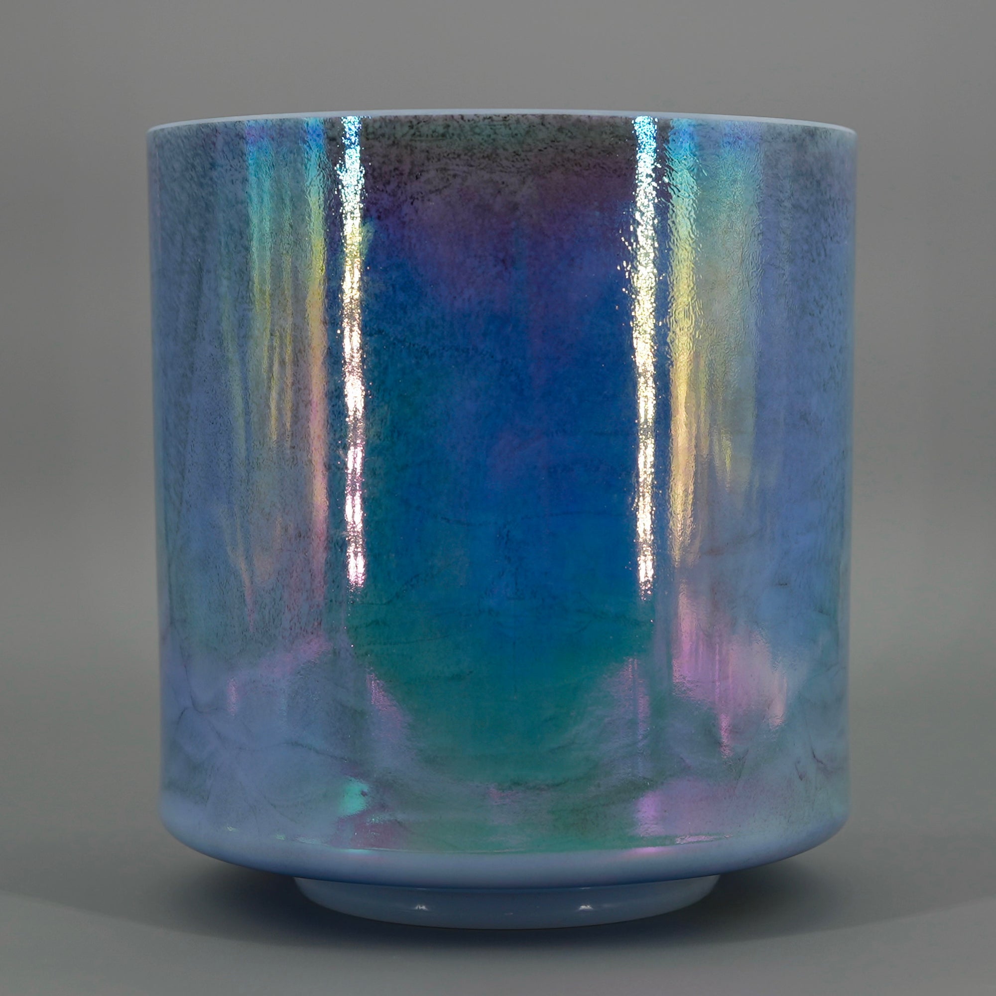 Iridescent crystal sound bowl on a gray background