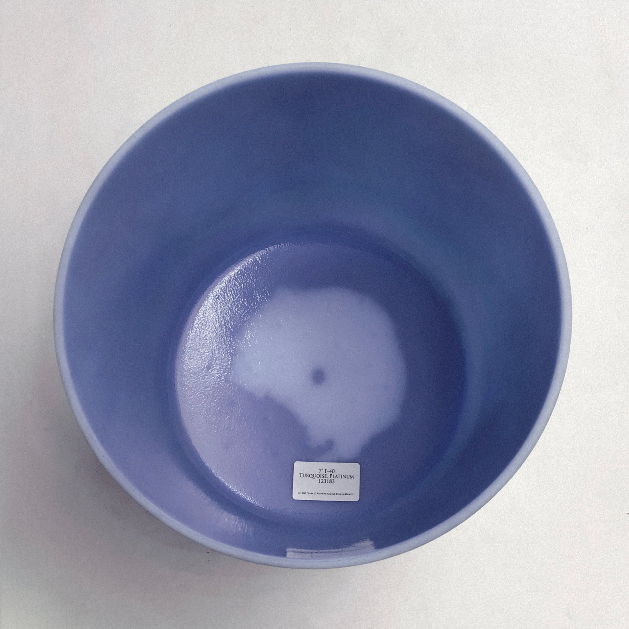 Blue crystal sound bowl on a white background