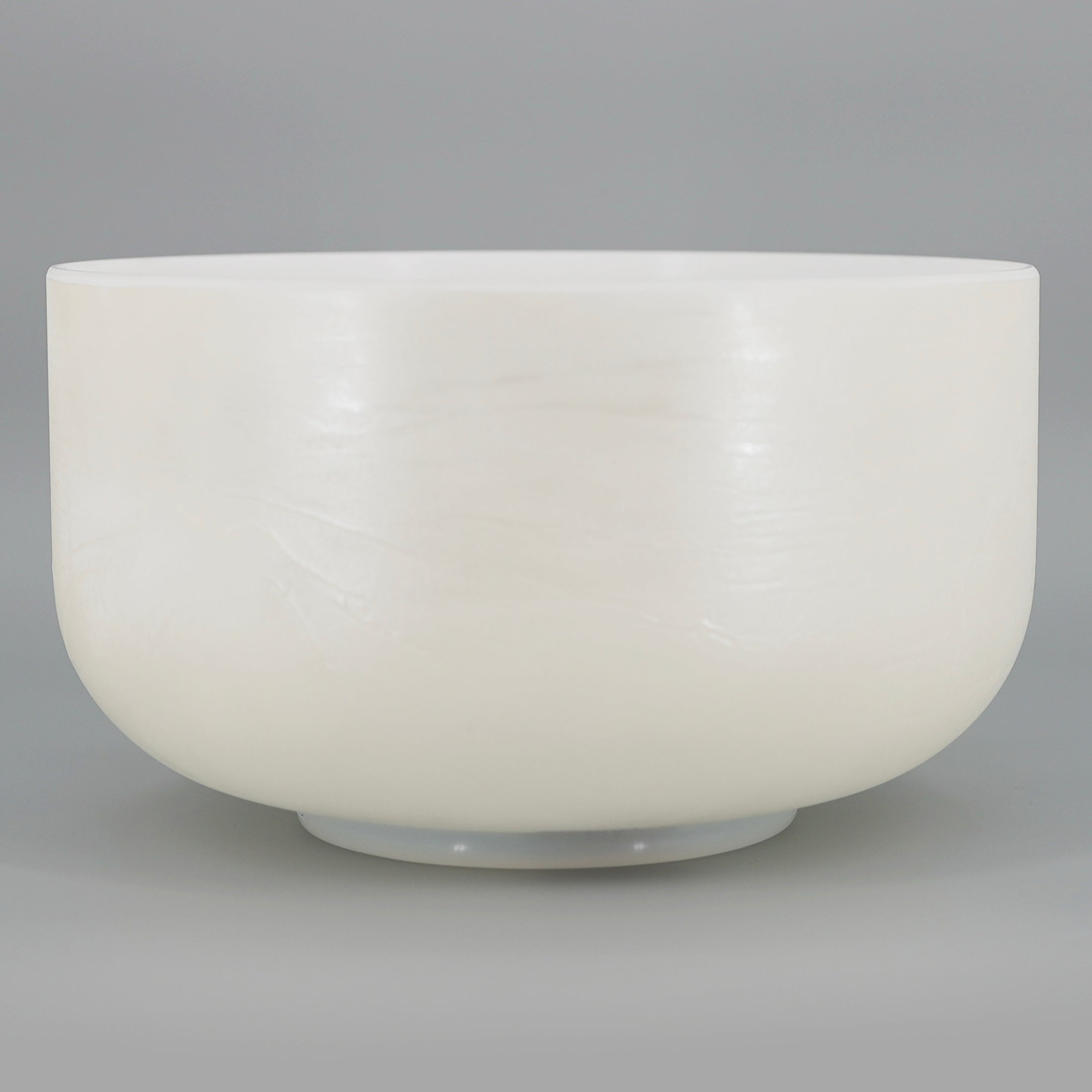 White Crystal sound bowl on a gray background