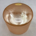 Load image into Gallery viewer, Orange crystal sound bowl with geometric design and label on a white background
