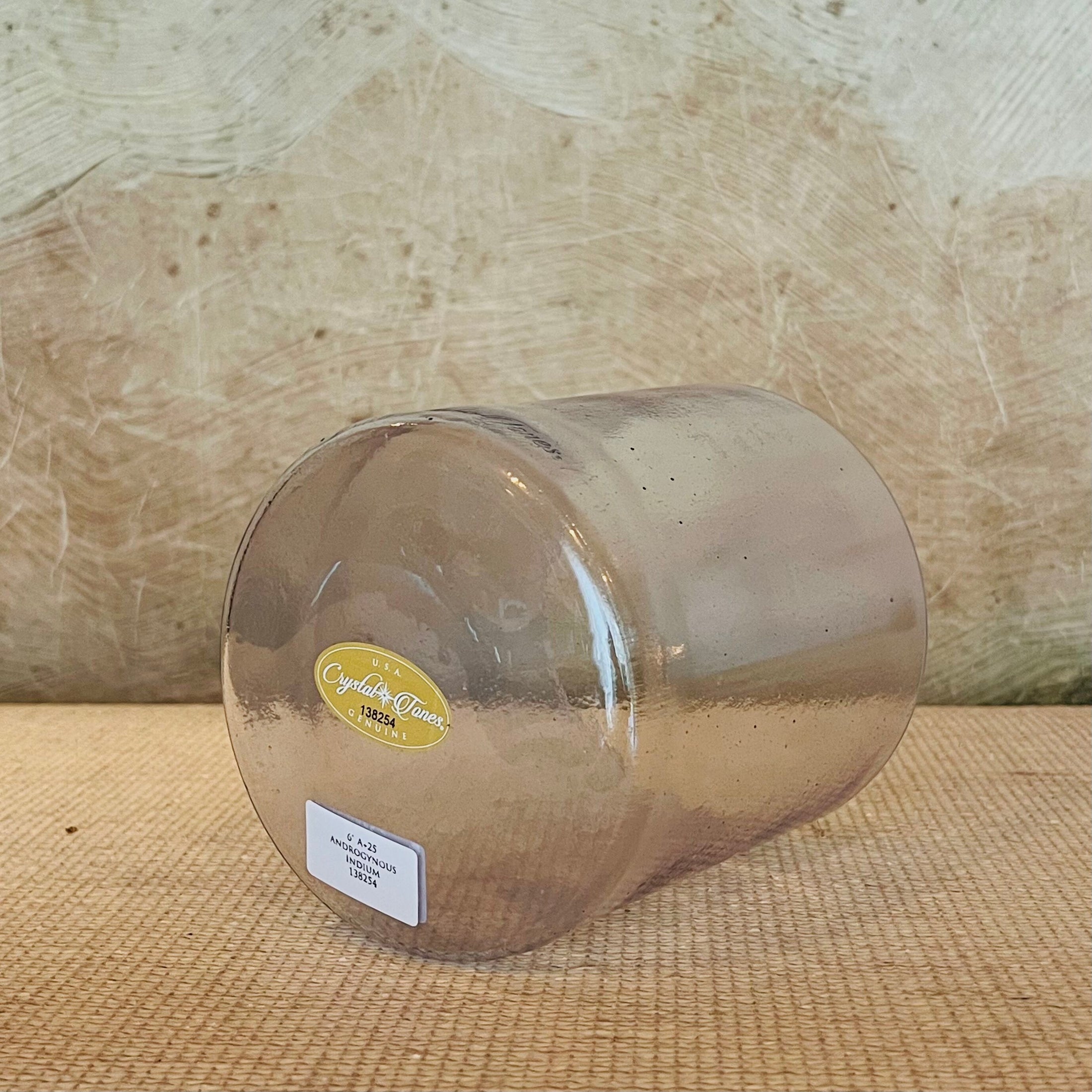 Clear crystal sound bowl with a Crystal Tones label on a wooden surface