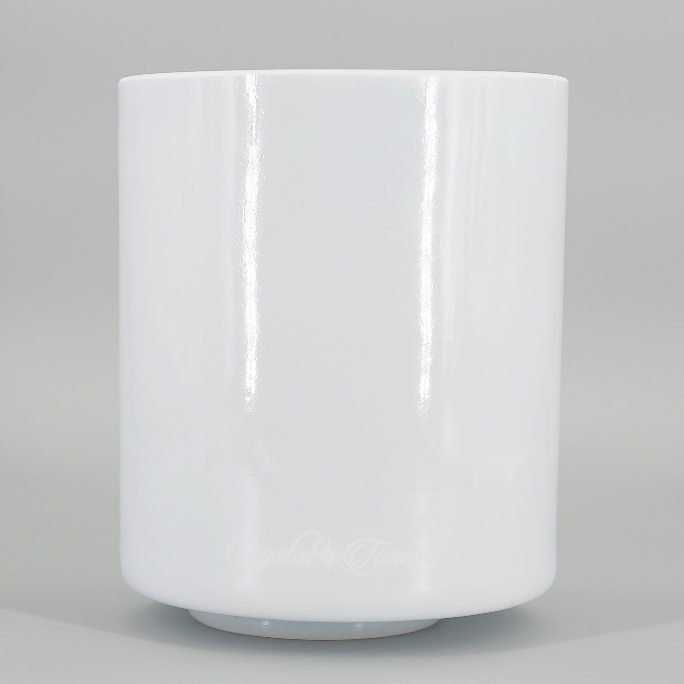 White crystal sound bowl on a gray background