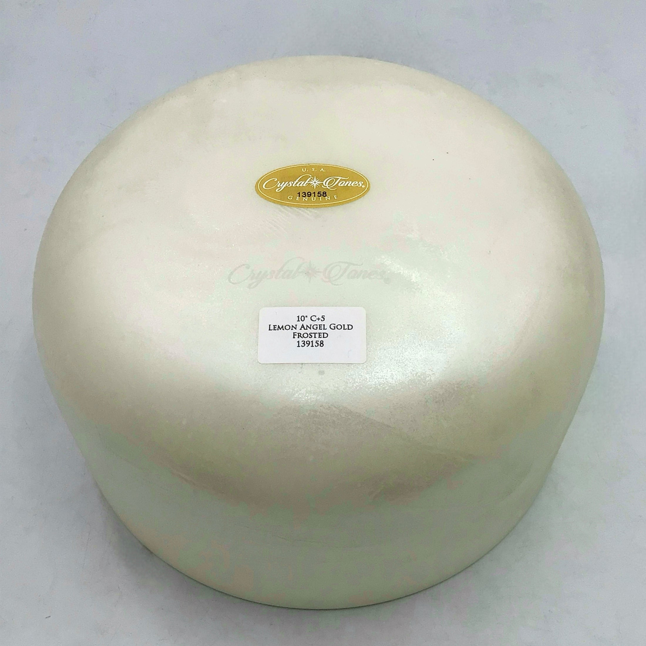 View of the base of a white Crystal sound bowl with labels 