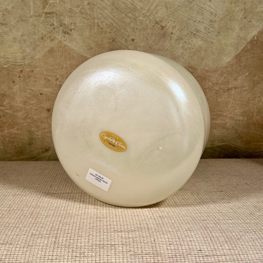 Round crystal sound bowl with a Crystal Tones brand label on a textured surface