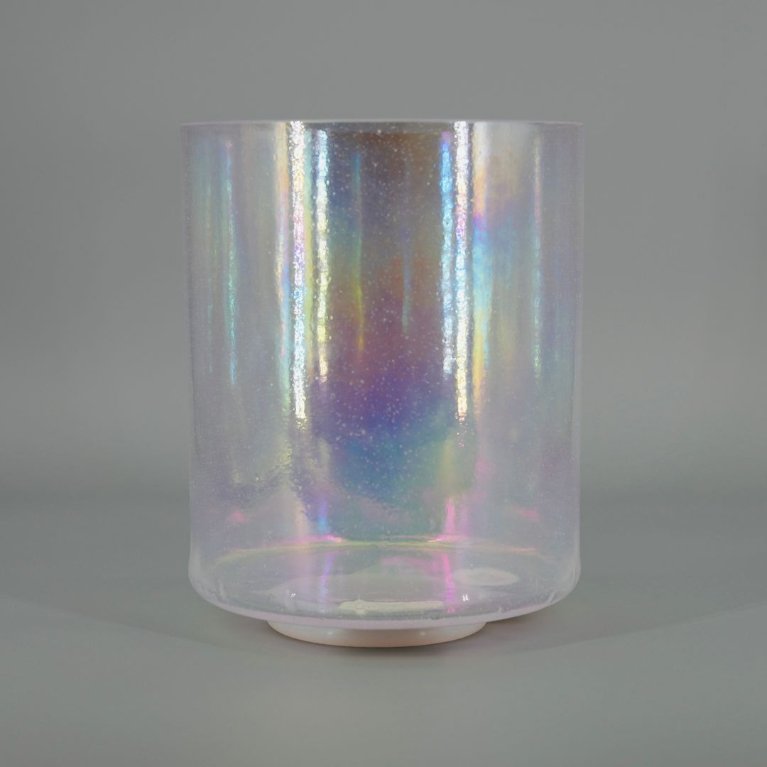 Iridescent crystal singing bowl on grey background