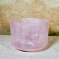 Load image into Gallery viewer, Pink crystal sound bowl on a textured surface with a neutral background
