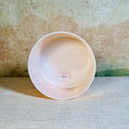 Load image into Gallery viewer, White crystal sound bowl with a label on a textured surface
