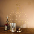 Load image into Gallery viewer, Decorative setup with candles and a crystal sound bowl on a wooden surface, featuring 'Crystal Sound Sanctum' logo.
